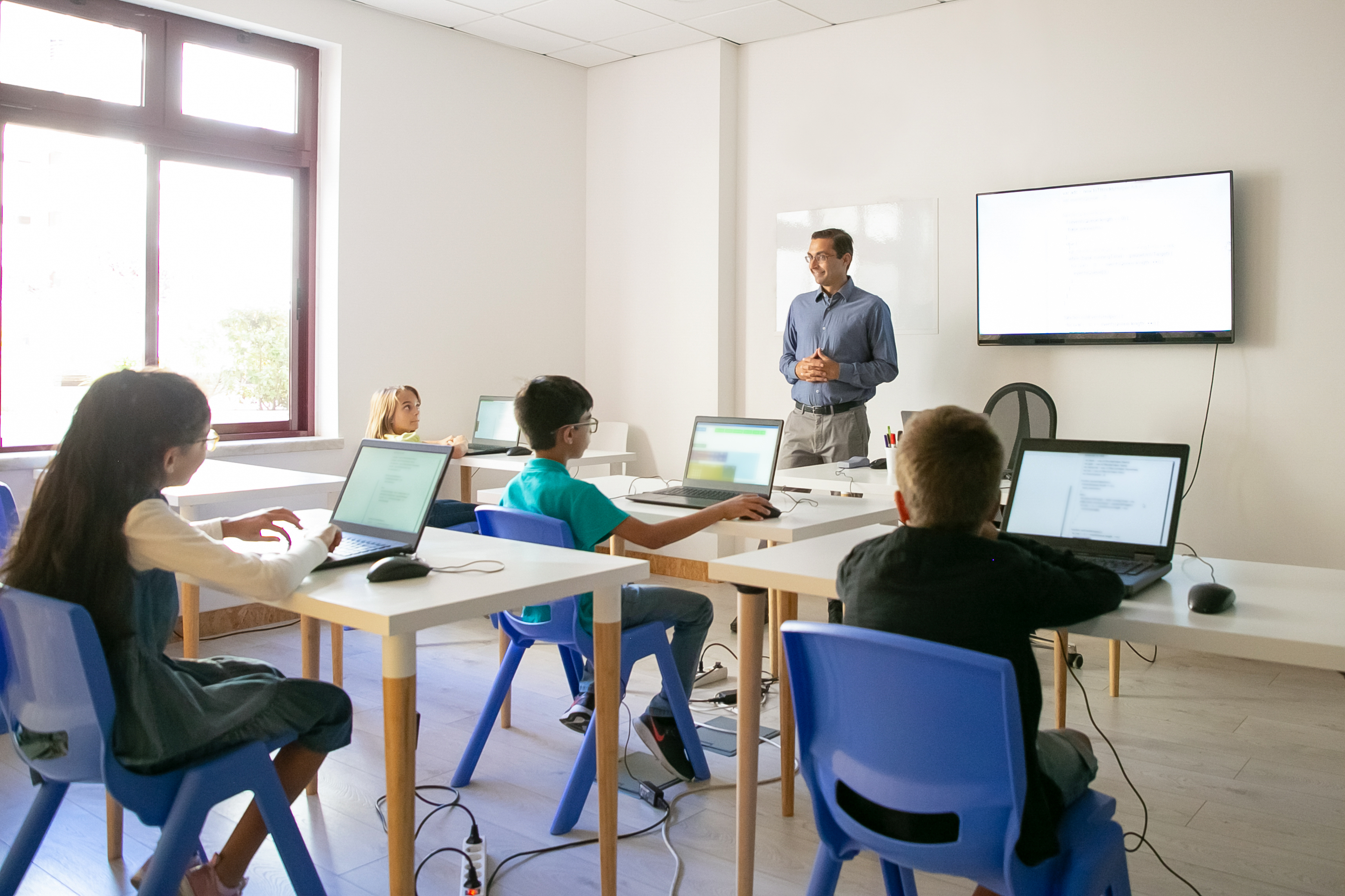 Confident teacher explaining lesson to pupils